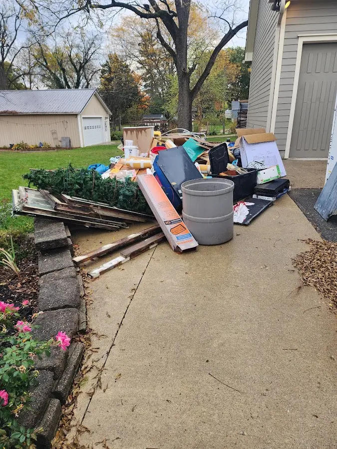 Dumpster being loaded with debris for Roofing Dumpster Rental in Newburyport